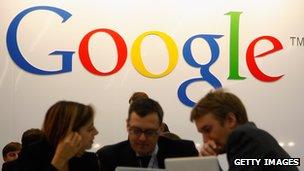 Computer users in front of a Google logo at Frankfurt Book Fair