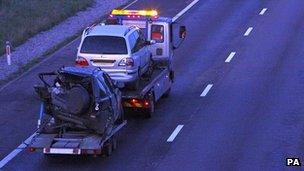 A car is removed from the crash scene