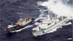 Handout picture taken by Japan Coast Guard on November 6, 2011 shows a Chinese fishing boat (L) being chased by a Japanese Coast Guard