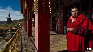 A young monk stands at Tibetan monastery in Sichuan province's Hongyuan county on 19 October 2011