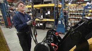 A Caterpillar employee tests equipment in a factory