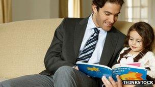 Father reading to daughter