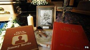 A photo, cigars and This Is Your Life books next to the golden coffin of Sir Jimmy Savile