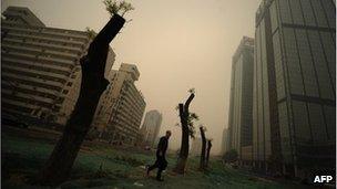 A man walks through heavy pollution on a street in Beijing on November 1