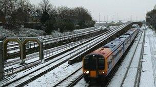 A train travelling on snow-covered tracks