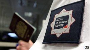 UK border official checking a passport