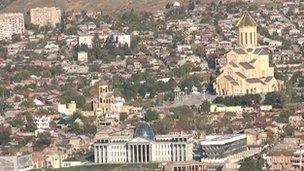 The presidential palace in Tbilisi on the left and the cathedral Mr Ivanishvili paid for on the right