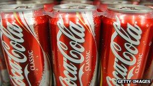 Cans of Coca-Cola on a shelf