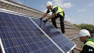 Workmen installing solar panels