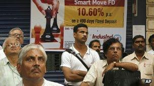 Indians outside the stock exchange in Mumbai