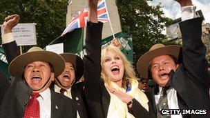 Actress and Gurkha campaigner Joanna Lumley celebrates with retired Gurkha soldiers adjacent to the Houses of Parliament on May 21 2009 in London.