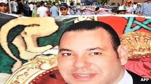 Protesters hold up poster of King Mohammed VI of Morocco during a June 2011 demonstration in support of the king's constitutional reforms