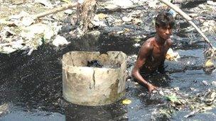 Man standing in putrid water