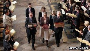 Ancient copies of the King James Bible are carried during a procession at Westminster Abbey