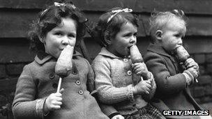 Children eating carrots on sticks