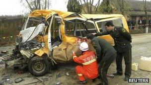 Investigators examine the bus in Zhengning county on 16 November 2011