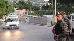 Military guarding the entrance to the area known as El Infiernito - Little Hell - as part of Operation Lightning