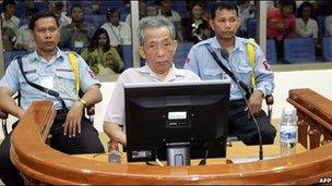 Kaing Guek Eav better known as "Duch" (C) sits in a dock in the court room at the Extraordinary Chambers in the Courts of Cambodia in Phnom Penh on December 5, 2008