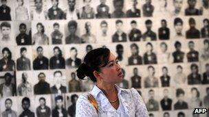 File image of a Cambodian woman looking at images of those who died at Tuol Sleng prison