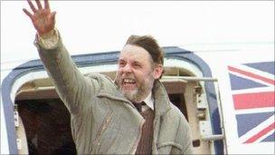 Terry Waite waves from a plane after landing in England