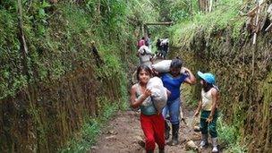 Awa people building a barn for livestock on their resettlement land