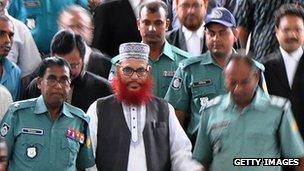 Delwar Hossain Sayedee (C) emerges from the Bangladesh International Crimes Tribunal in Dhaka on August 10, 2011