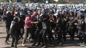 Egyptian riot policemen scuffle with a protester at Cairo's landmark Tahrir Square on Saturday following clashes after police dispersed a sit-in