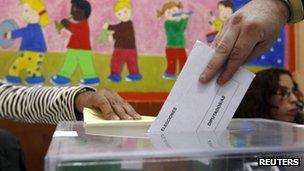 A man votes in Spain's general elections at a polling station in the Andalusian capital of Seville, 20 November 2011