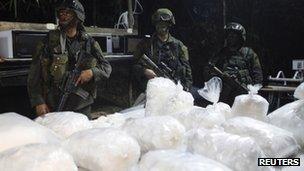 Colombian anti-drugs police guard a cocaine laboratory in the town of Guaracu, Puerto Gaitan province in Meta, 13 October 2011