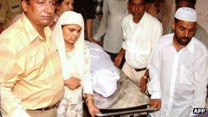 This file photo taken on 18 June 2004 shows Shamima Kausar (second from left) collecting the body of her daughter Ishrat Jahan from a hospital in Ahmedabad