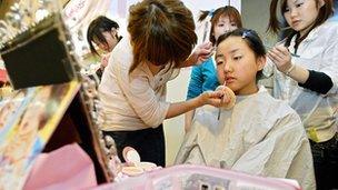 Girl having her make-up done