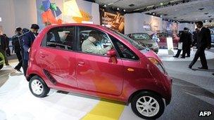 This 5 January 2010 file photograph shows visitors as they inspect Tata Motor's cheapest car "Nano" at Pragati maidan during the 10th Auto Expo 2010 in New Delhi.