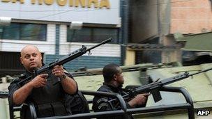 Paramilitary police commandos patrol a street of the Rocinha shantytown in Rio de Janeiro, Brazil, on 13 November 2011