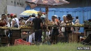 People buy food at a market in Havana on 12 November 2011