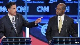 Former Massachusets governor Mitt Romney (L) and US businessman Herman Cain (R) during the Republican presidential debate on national security in Washington - 22 November 2011