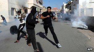 Protesters run for cover as Bahraini police fire tear gas (14 February 2011)