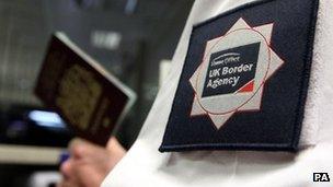 Border agency worker checking a passport