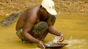 A miner panning for gold in Mahdia, central Guyana