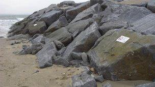 The warning signs on the rocks at Tywyn beach