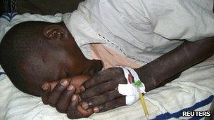 An injured man lies in a hospital bed after an attack in Garissa, 24 November 2011.