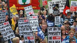 Protesters holding say no to poverty placards