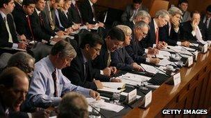 Super Committee members seated at desk