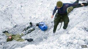 A Sirius Patrol soldier sets about rescuing another from icy water
