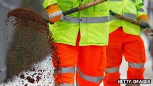 Council workers spread grit