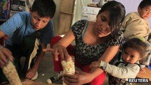 Family in Peru's capital, Lima, preparing popcorn to sell in the shantytown of Pamplona Alta