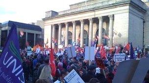 Strikers gather outside Barkers Pool in Sheffield to prepare to march