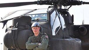 Prince Harry with an Apache helicopter