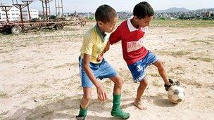 Young boys playing football in Sao Paulo