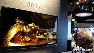 A man looks at a 3D television