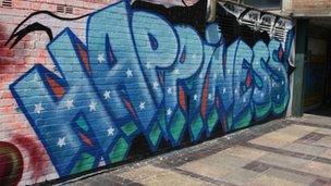 The word happiness forms part of graffiti art in central London